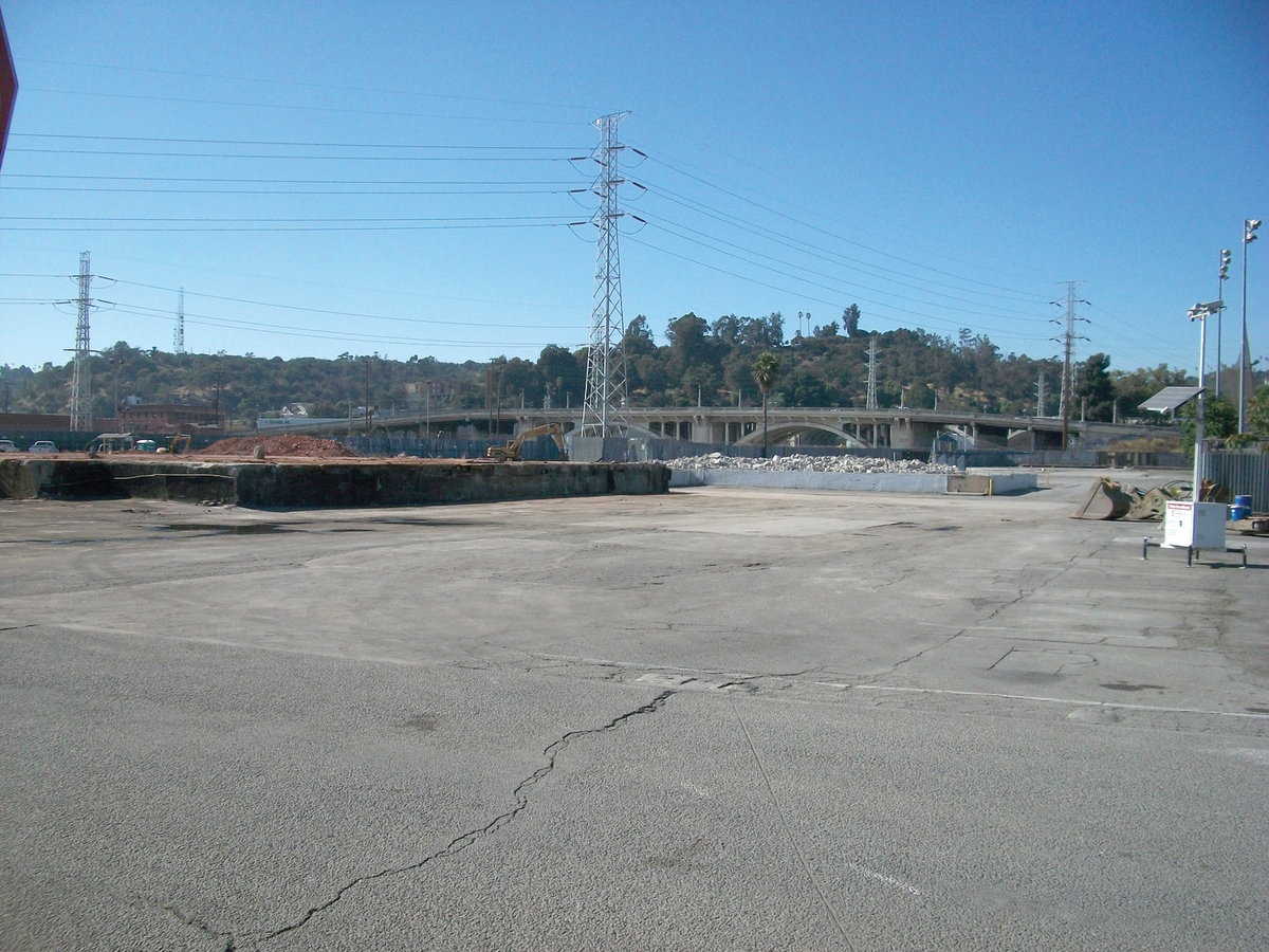 Before construction, a paved vacant lot overlooking the L.A. River
