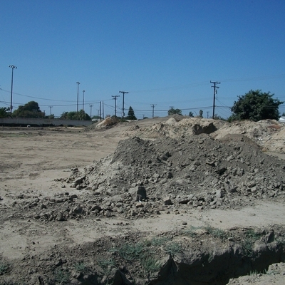 Vacant lot with dirt piles that would become Creek-Washington Natural Park