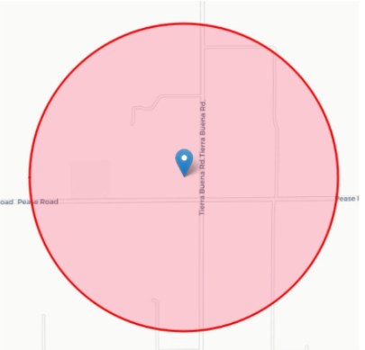 A map centered on a red circle around a blue pin. The map also shows streets.