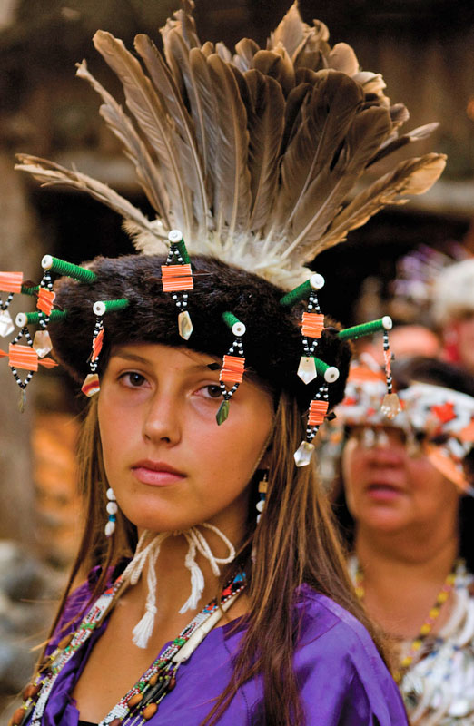 A woman wearing colorful traditional Native American clothing