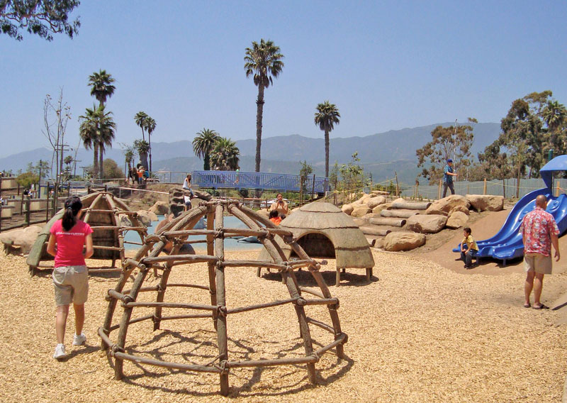 Families play in a kids play area built to look like a Chumash Indian Village