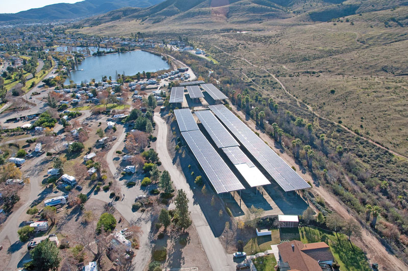 An oblique aerial view of a new solar panels covering a parking lot for a recreation preserve