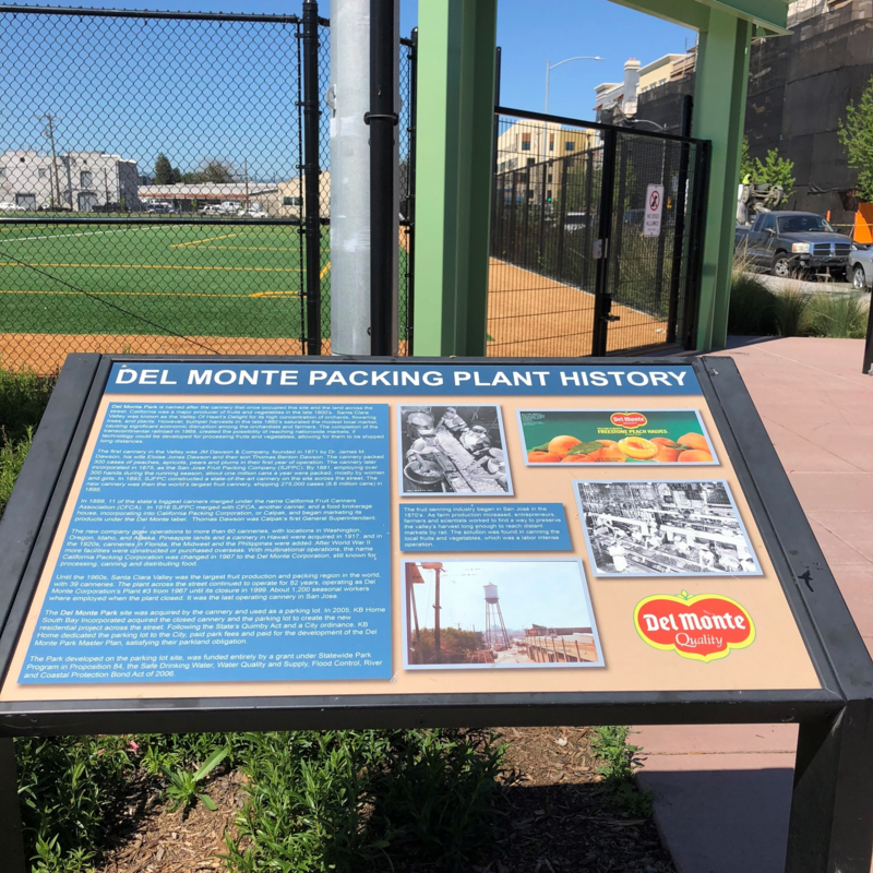 Angled sign with information about the history of the Del Monte packing plant.