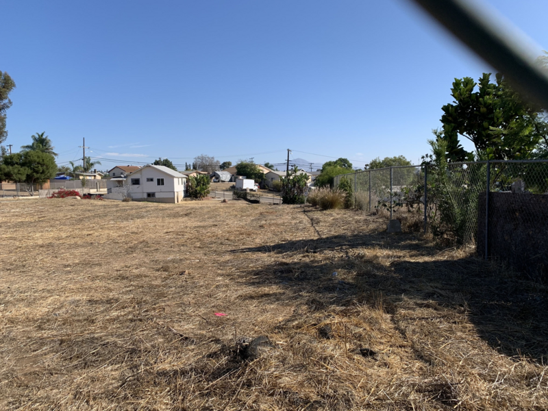 Vacant lot viewed through a chainlink fence
