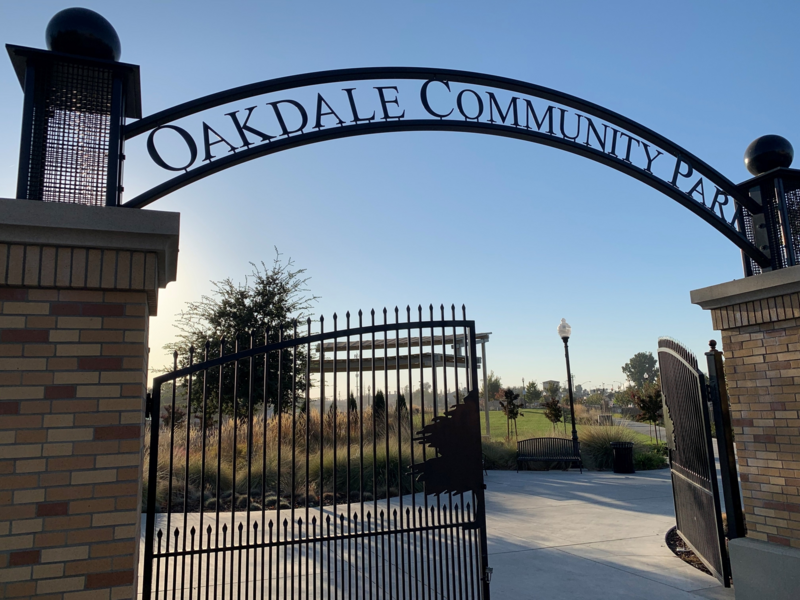 Brick and iron gate with letters that read Oakdale Community Park.