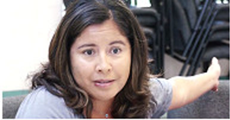 A woman speaking in a meeting in a conference room